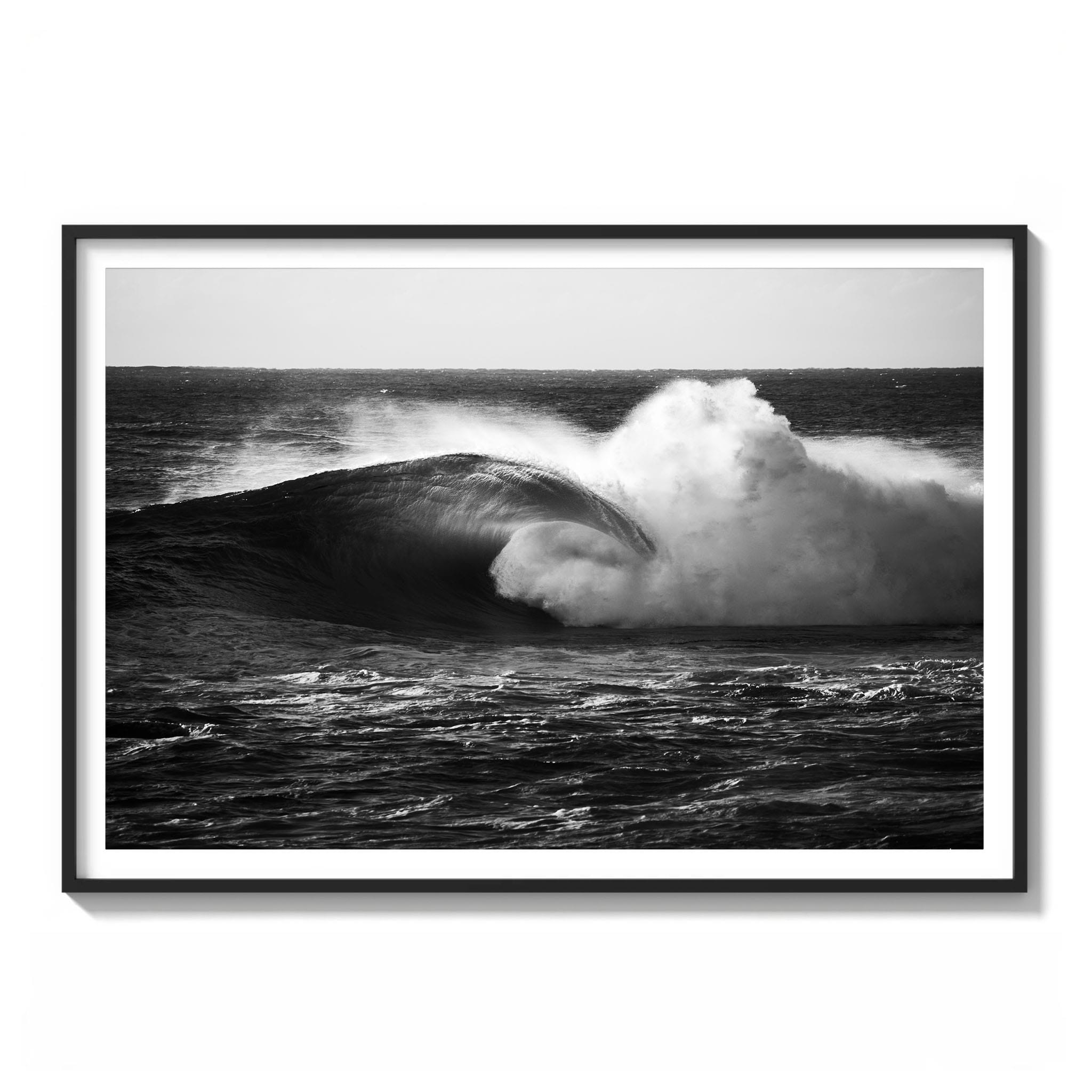 Framed black and white photograph of a large hollow wave breaking at Cape Solander with a clean pitching lip.