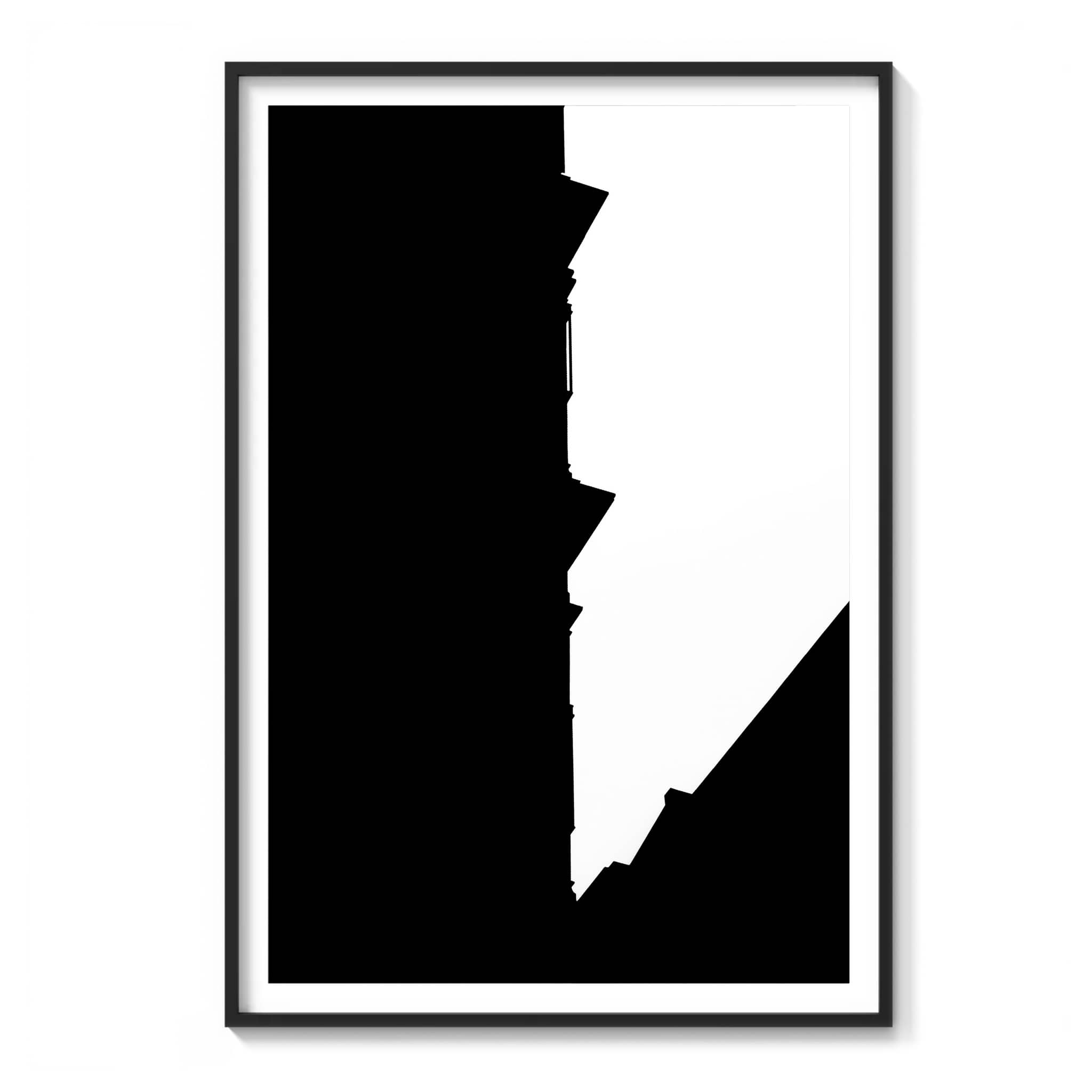 framed high-contrast black and white photograph of a jagged rooftop silhouette against a bright sky in New York City.
