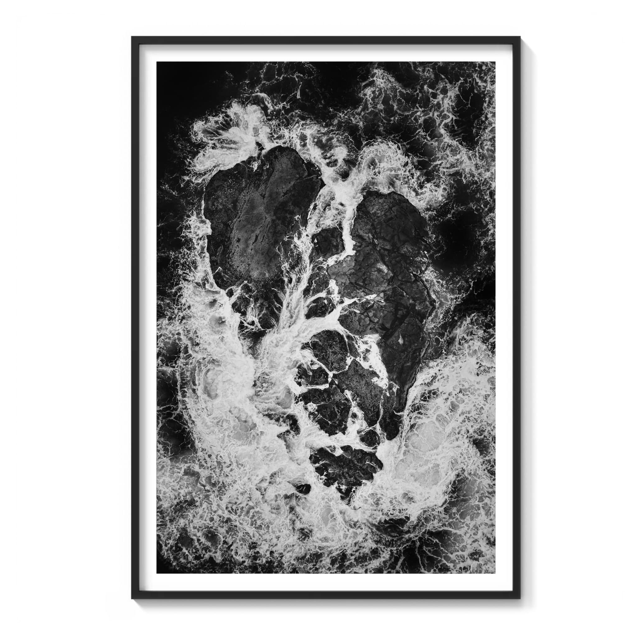 Framed aerial black and white photograph of a heart-shaped rock formation with white foam tracing through the cracks, Vancouver Island.