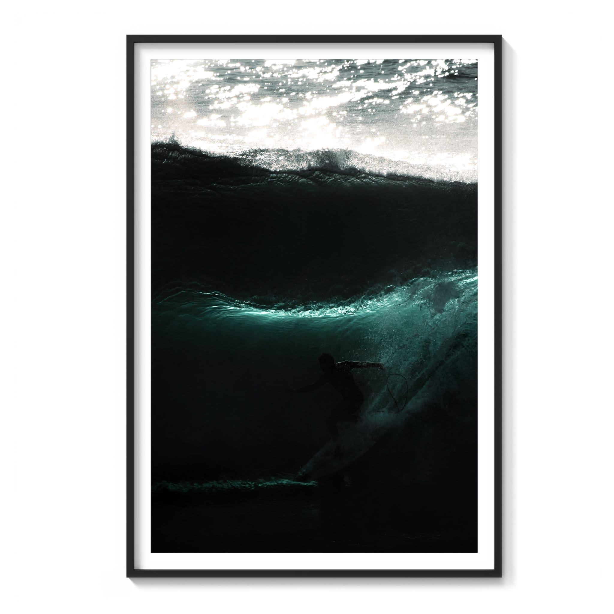 Framed color photograph of a surfer riding in silhouette inside a dark wave with a thin ribbon of turquoise light, Sydney.