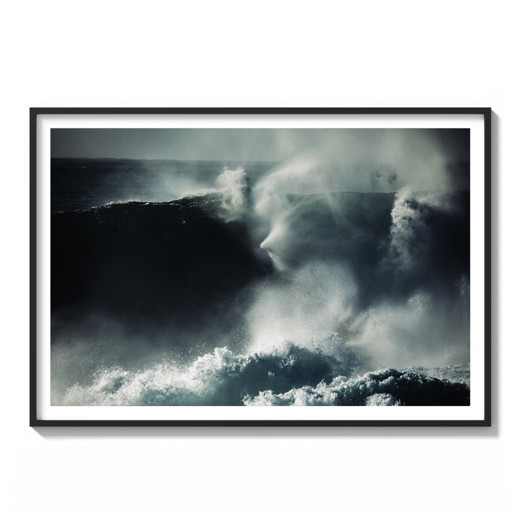Framed Black and white photograph of a heavy slab wave breaking near Sydney, with mist forming an eerie face-like shape above the barrel.