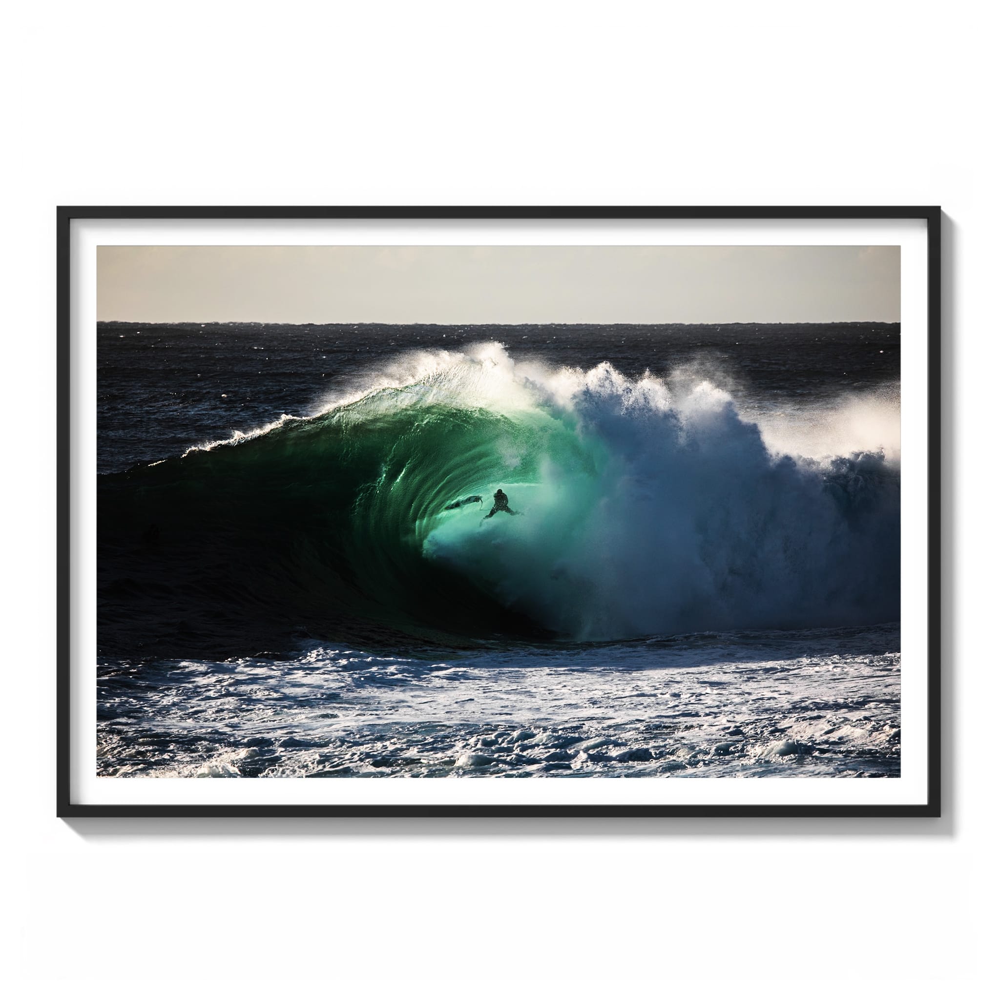 Framed color photograph of a surfer riding deep inside a dark green barrel wave at Cape Solander.
