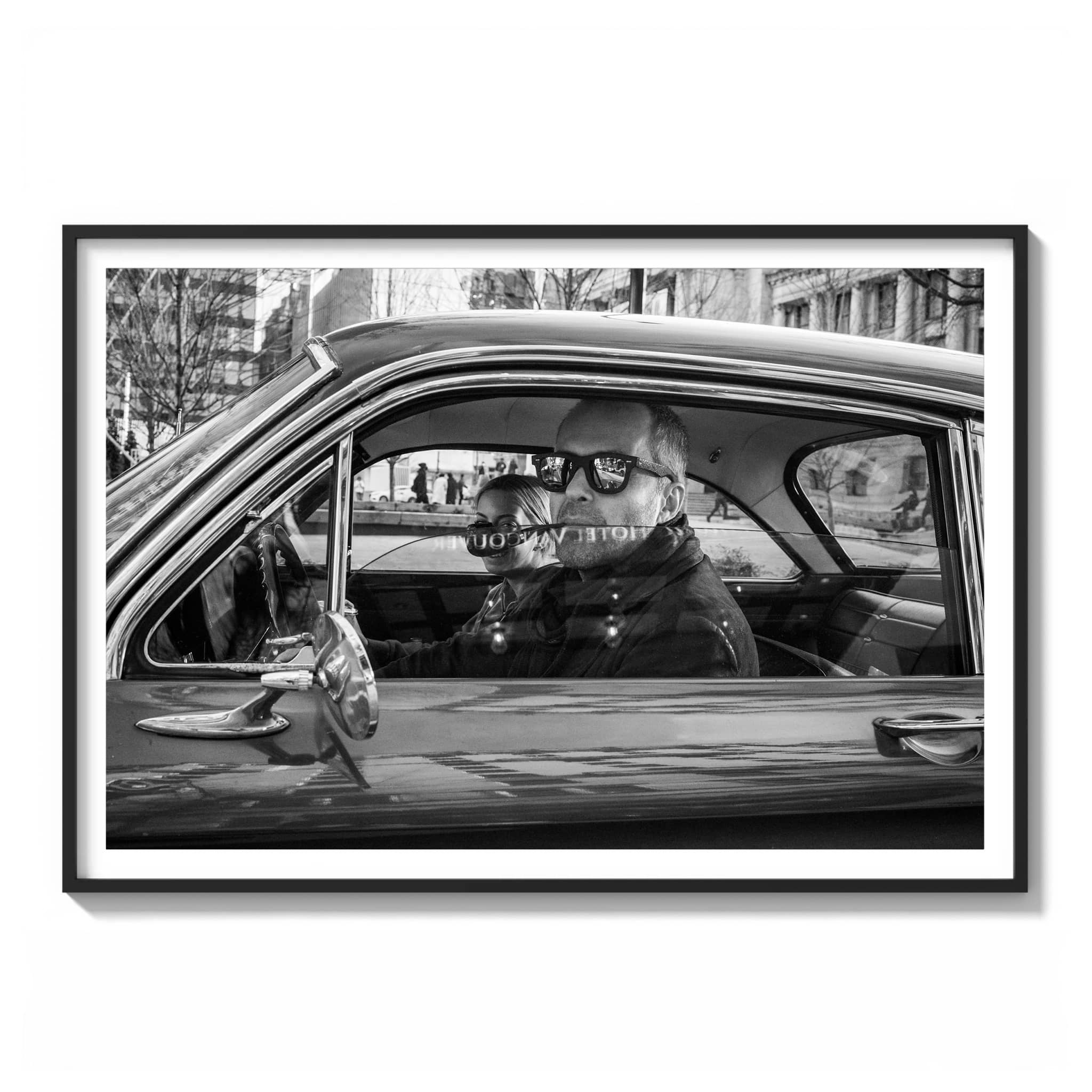 framed black and white photograph of a couple sitting in a vintage car with "Hotel Vancouver" reflected across the windshield.